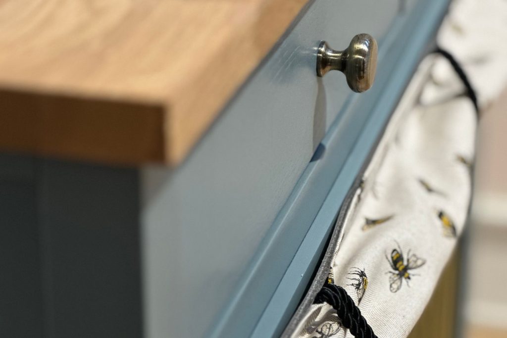 Close up photo of pet furniture showing bespoke paint De Nimes, with soft drop curtain and solid oak worktop