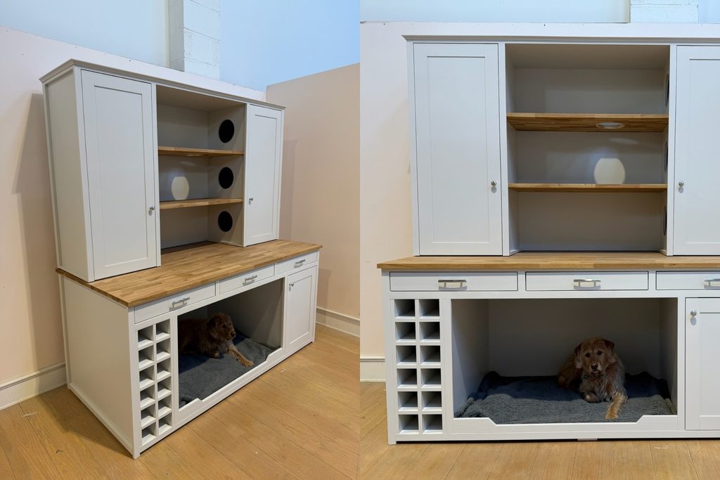 Ammonite pet dresser with solid oak worktop and shelves, silver handles, open dog bed for two cocker spaniels, wine rack, drawers and an upper cupboard converted into a cat cosy with circular access holes, with The Pet Carpenter's dog Finn lying in the bed