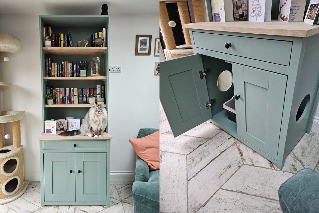 Vert de Terre cat litter tray cupboard with dresser top in a living room, whitewashed oak worktop and bookshelves, black knob handles and circular cat access holes, with a long-haired grey and white pedigree cat sitting on the worktop
