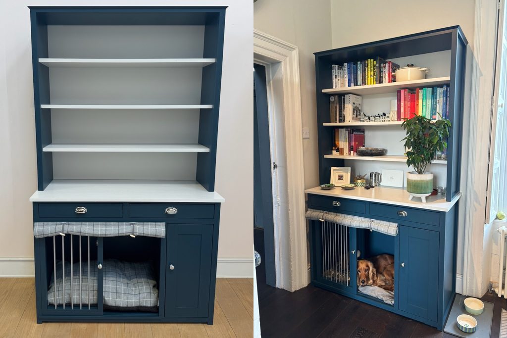 Hague Blue dog crate dresser in a kitchen with Ammonite worktop, open display shelves, silver cup handle drawers, sliding barred door and grey check drop curtain, with a cocker spaniel resting inside